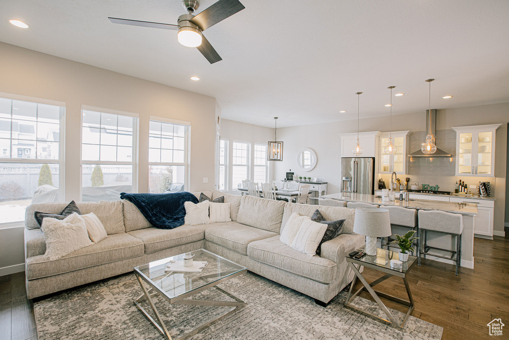 Living room featuring dark wood-type flooring, recessed lighting, and ceiling fan