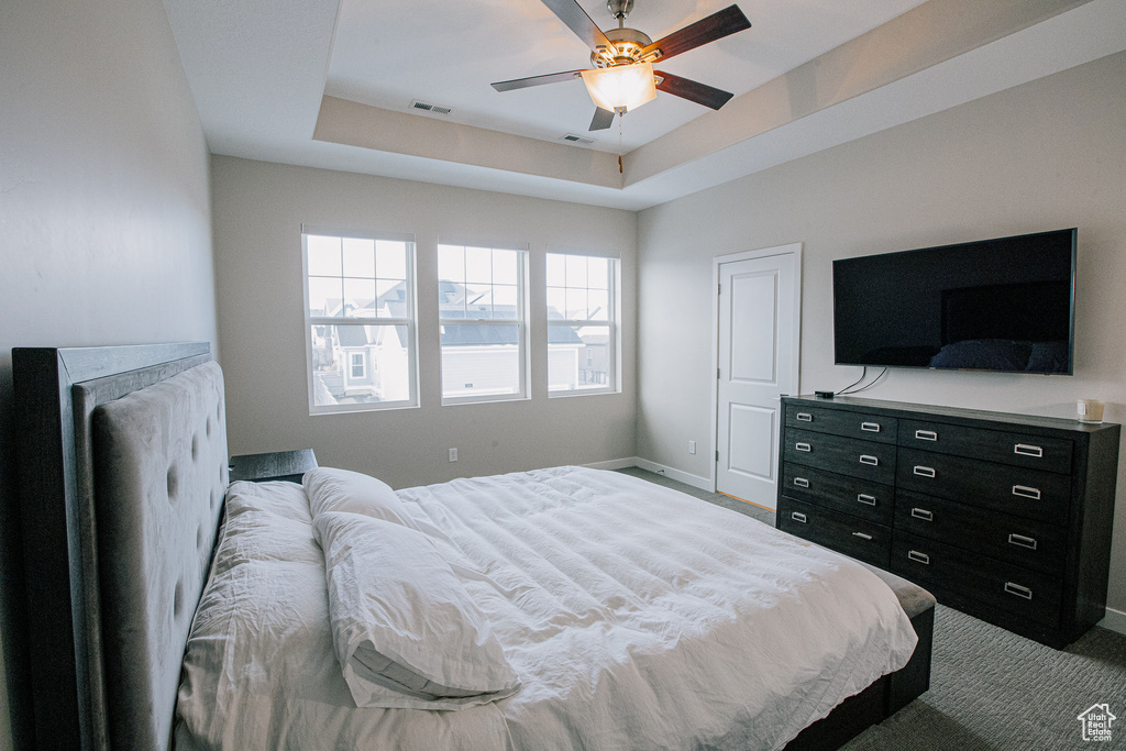Bedroom featuring baseboards, carpet, and ceiling fan
