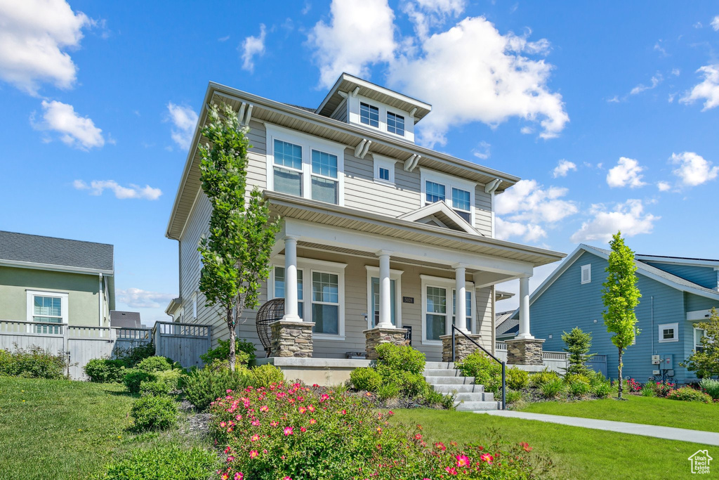 American foursquare style home with covered porch