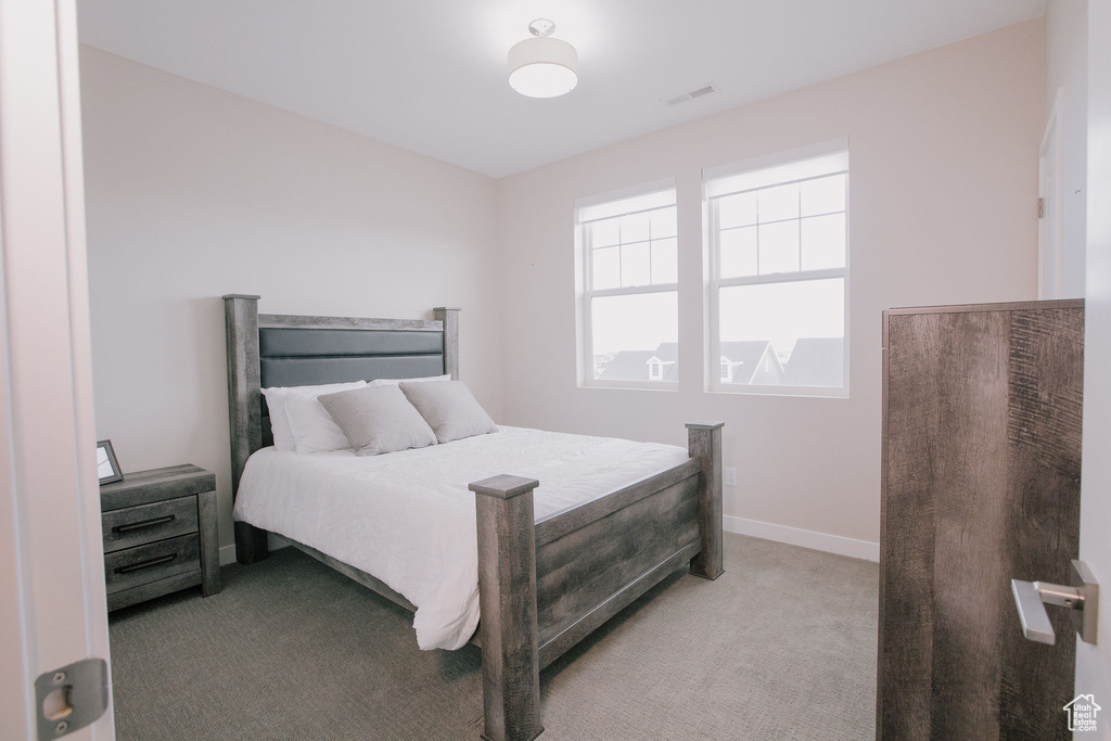 Carpeted bedroom with baseboards