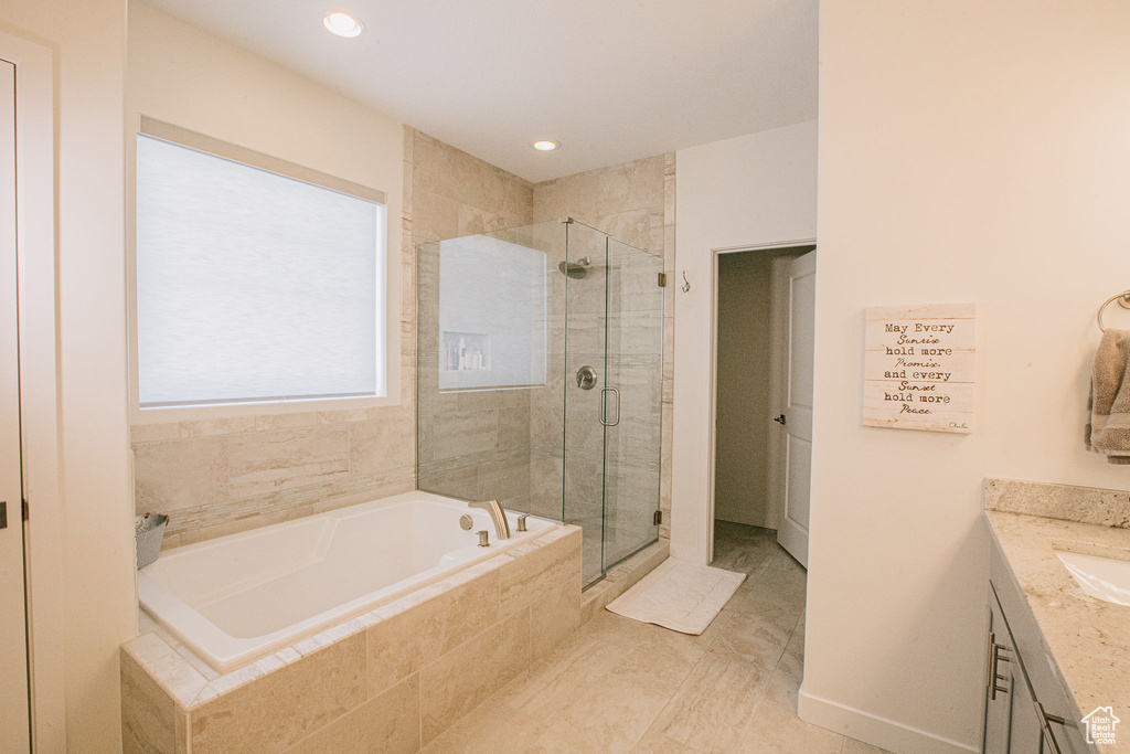 Bathroom featuring a garden tub, a shower stall, vanity, and recessed lighting