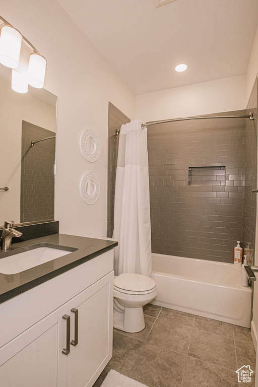 Full bath with vanity, shower / bath combo, and toilet