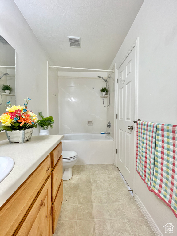 Full bathroom featuring vanity, shower / tub combination, tile patterned flooring, and toilet