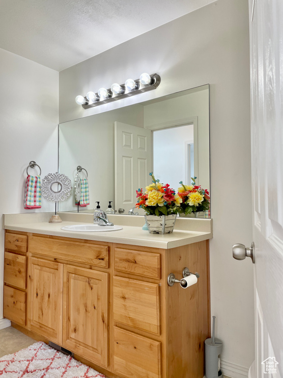Bathroom featuring vanity and tile patterned floors