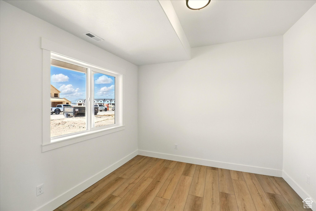 Empty room featuring light wood-style flooring and baseboards