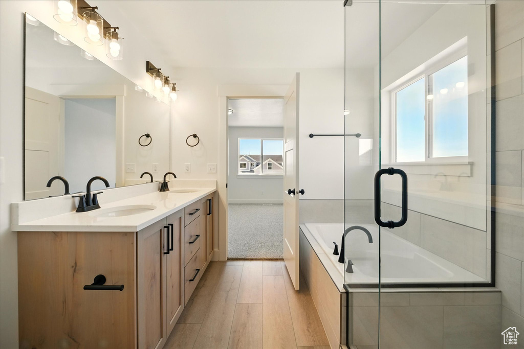 Bathroom with wood finished floors and double vanity