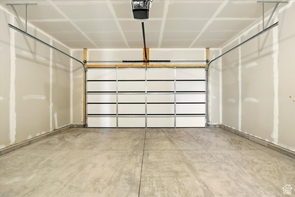 Garage featuring a garage door opener