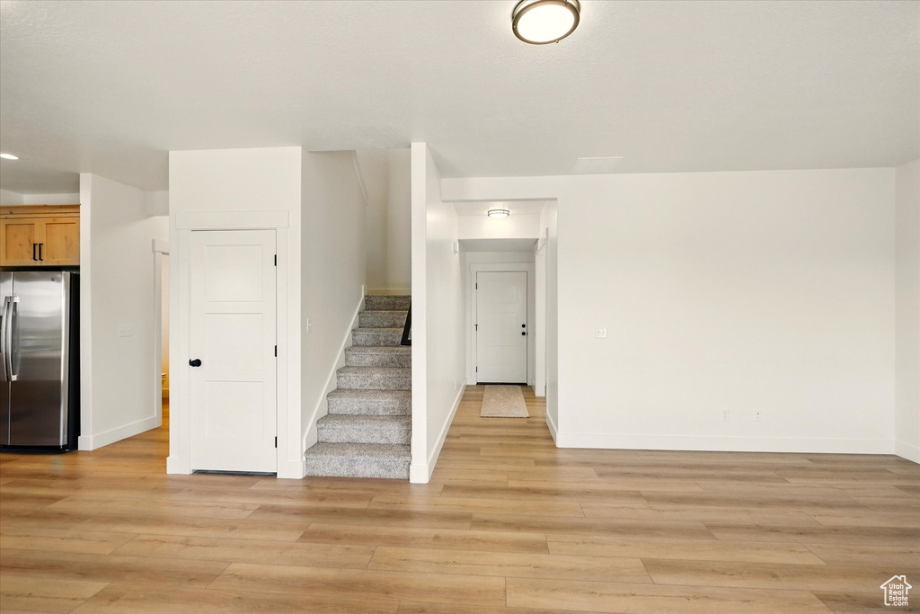 Staircase with wood finished floors and baseboards