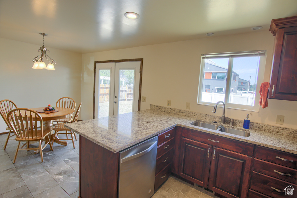 Kitchen with a sink, dishwasher, a peninsula, french doors, and reddish brown cabinets