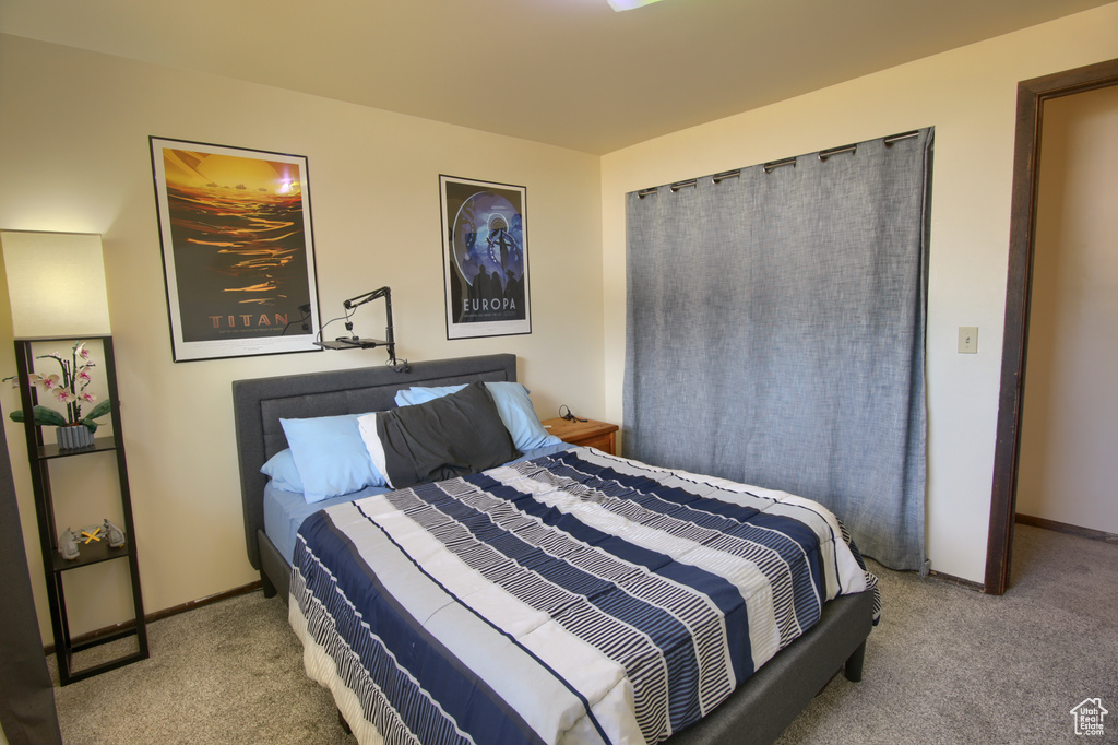 Carpeted bedroom with baseboards
