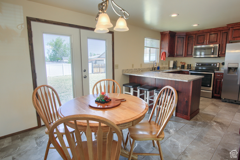 Dining area with recessed lighting and baseboards