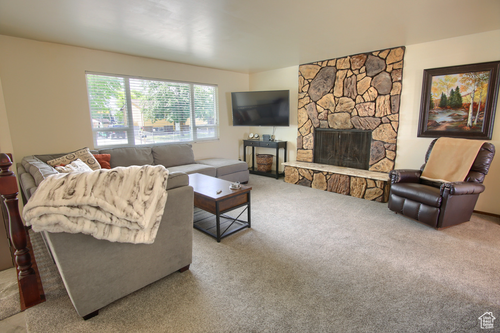 Living room featuring carpet and a fireplace