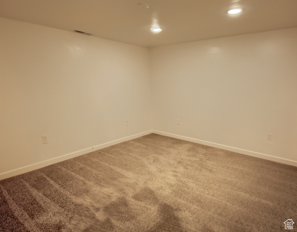 Carpeted spare room featuring recessed lighting and baseboards