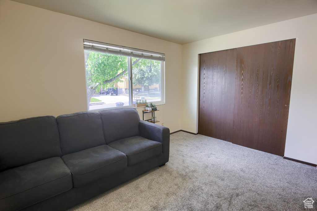 Living room with carpet flooring and baseboards
