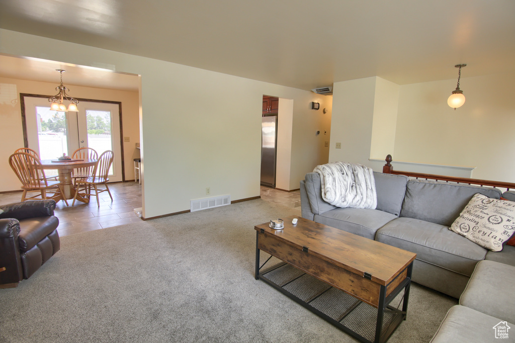 Living area featuring light colored carpet and baseboards