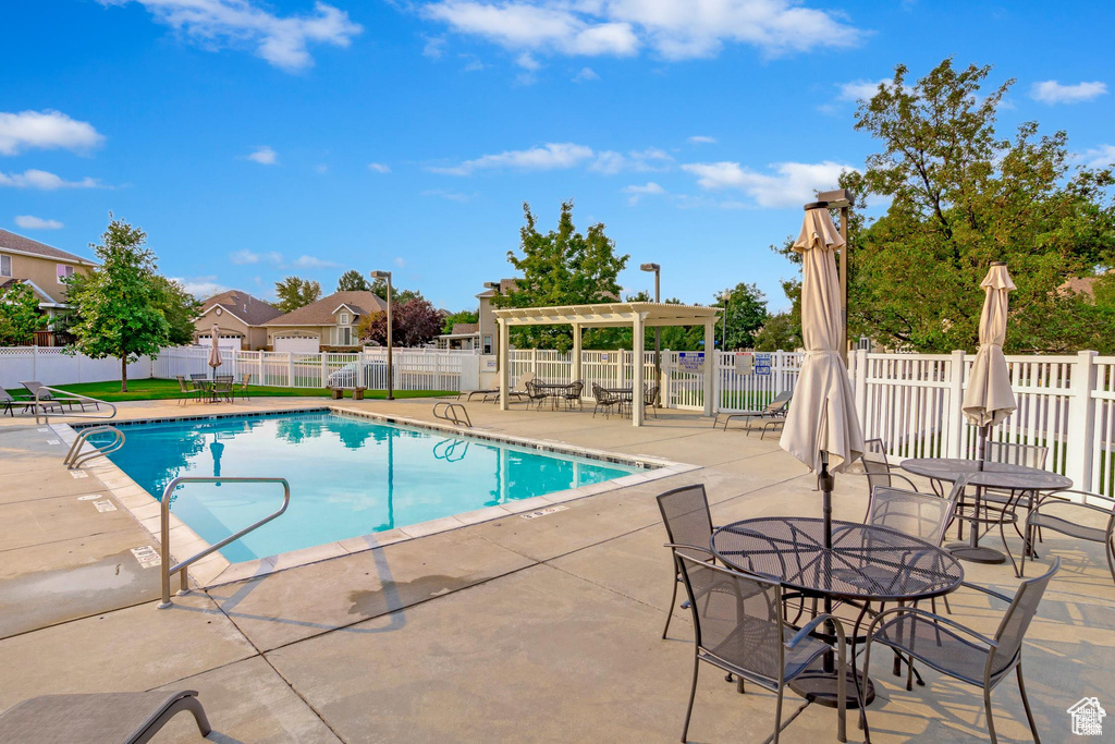 Community pool featuring a patio area and a pergola