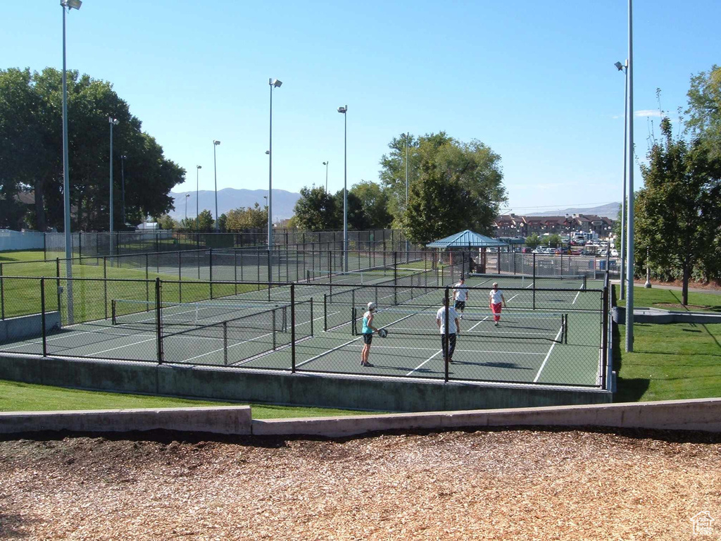 View of tennis court with a mountain view