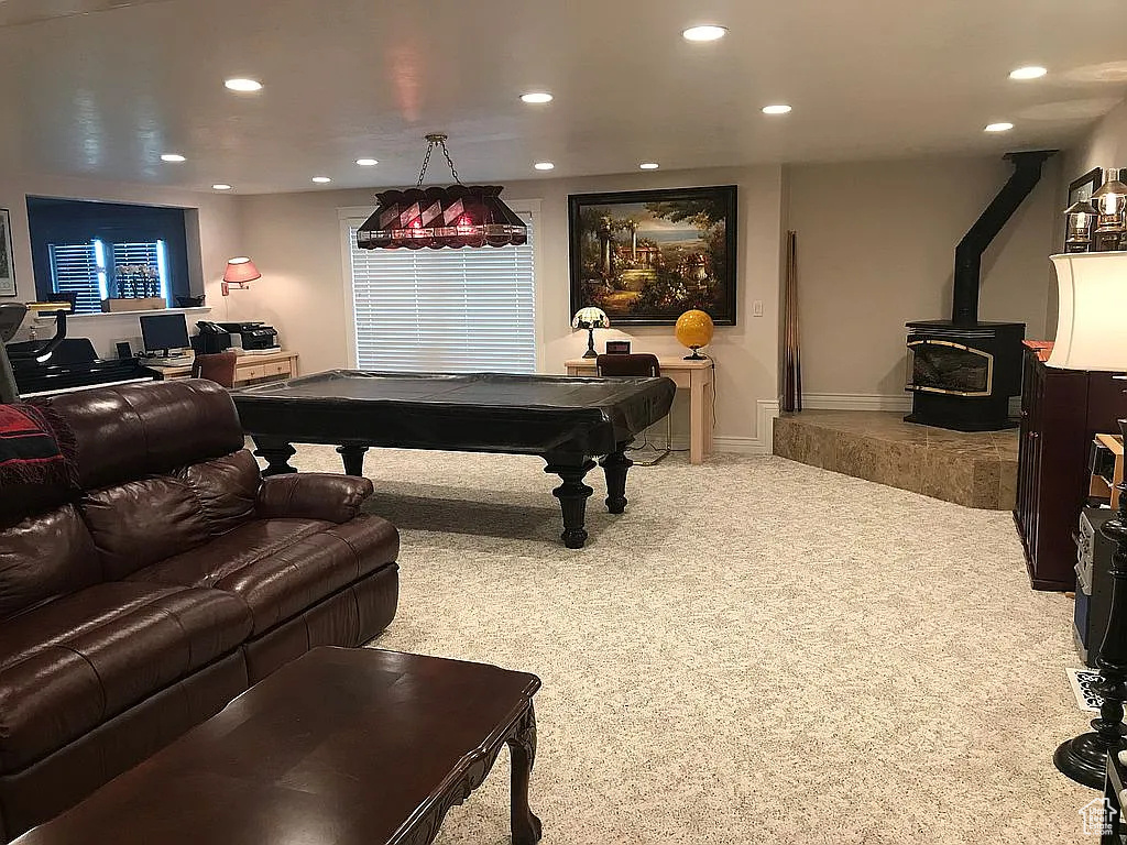 Game room with carpet floors, pool table, recessed lighting, a wood stove, and baseboards