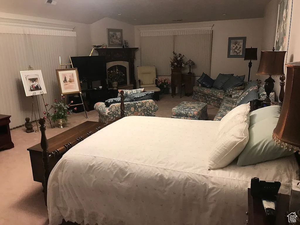 Bedroom with carpet flooring and lofted ceiling
