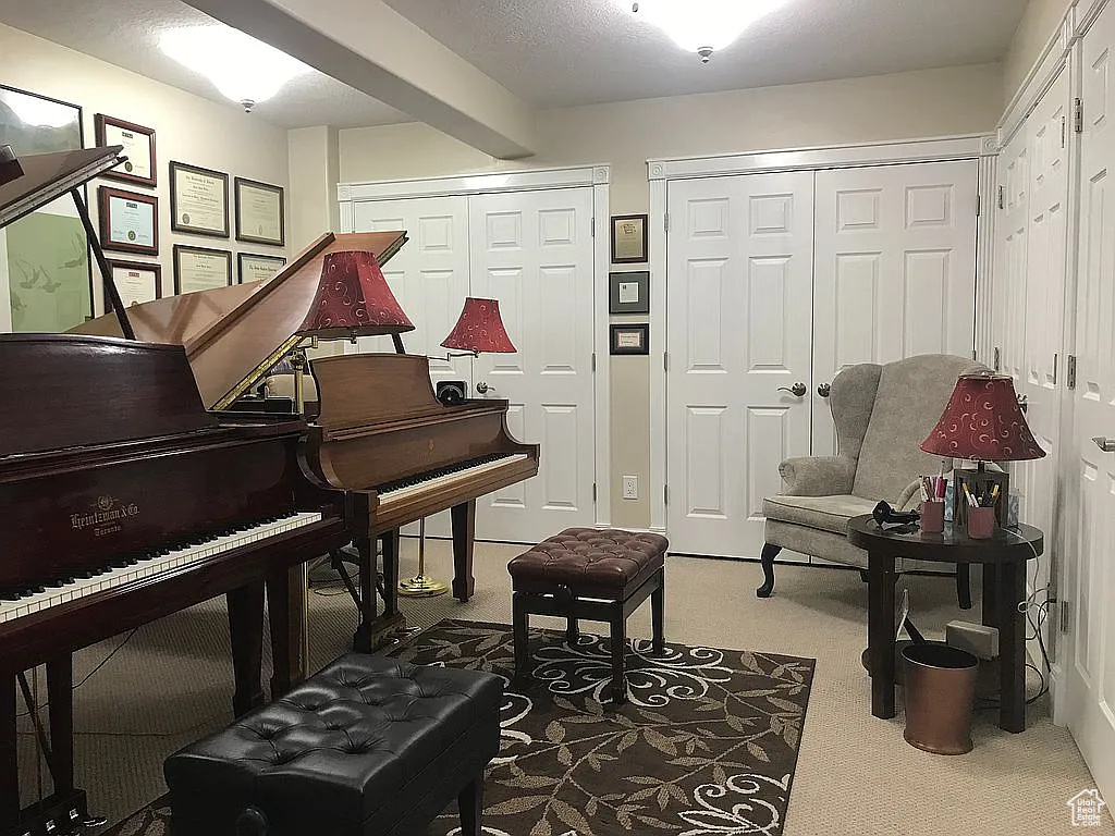 Sitting room featuring carpet floors