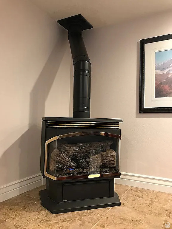 Detailed view of baseboards and a wood stove