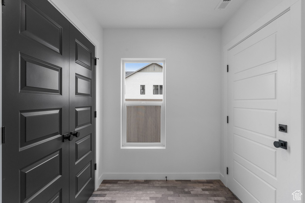 Foyer entrance with wood finished floors and baseboards