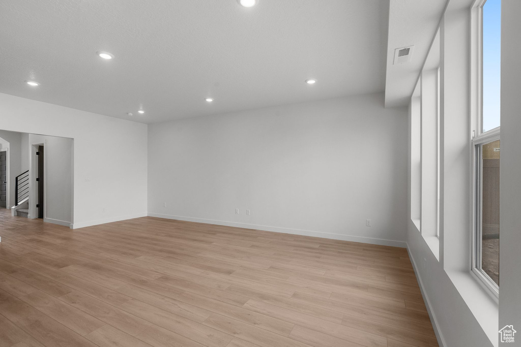 Unfurnished room with light wood-style floors, recessed lighting, and baseboards