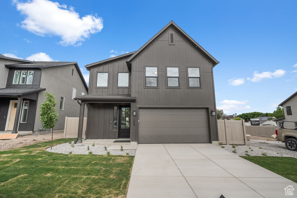View of front of property with a garage and concrete driveway