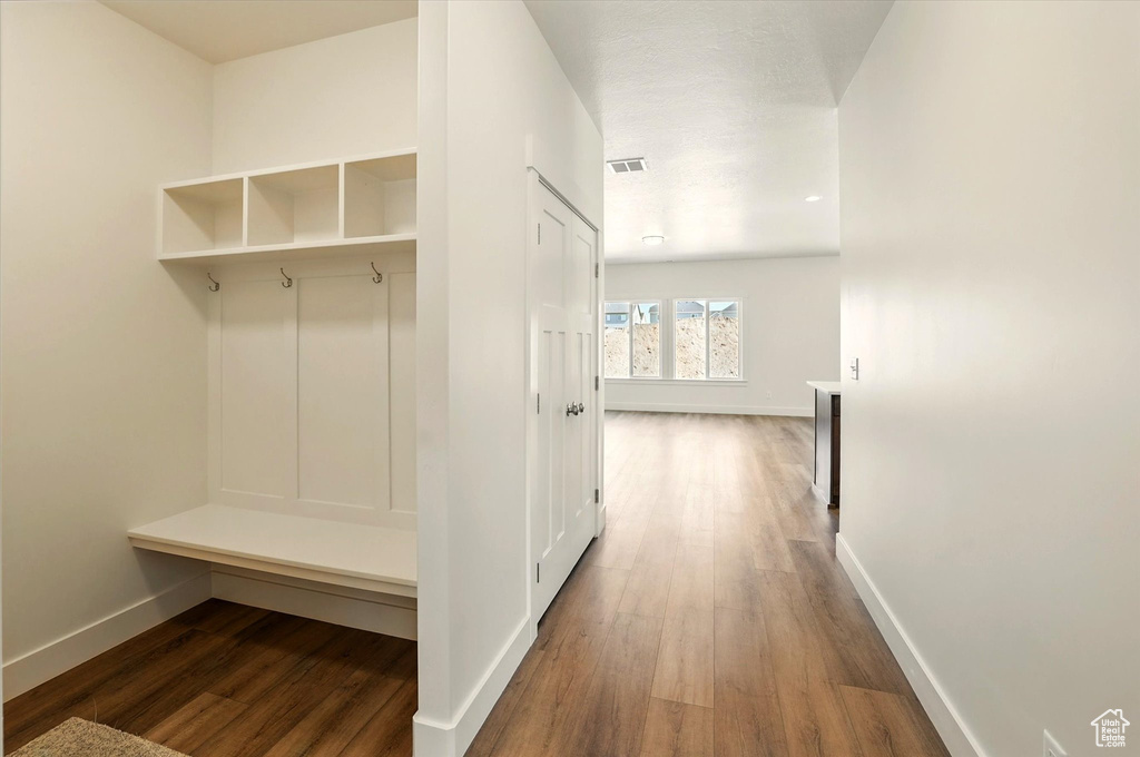 Mudroom with baseboards and wood finished floors