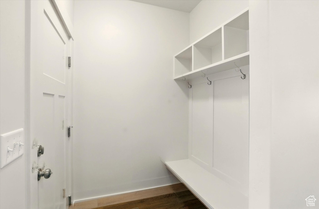 Mudroom featuring dark wood-style flooring and baseboards