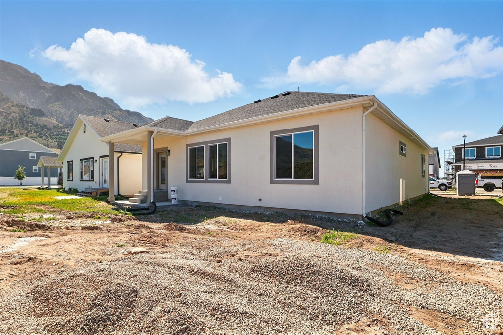 Back of property with a mountain view
