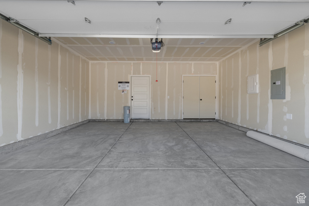 Garage with electric panel and a garage door opener