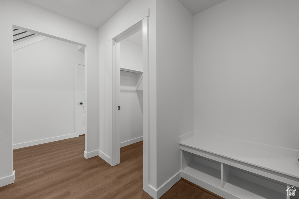 Mudroom with wood finished floors and baseboards