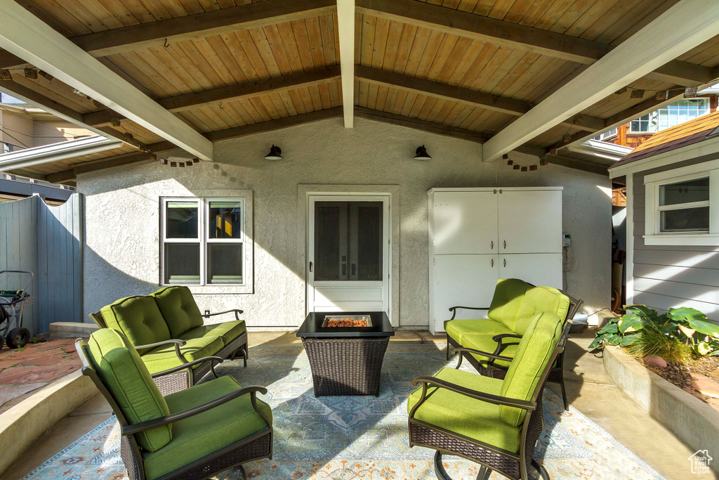 View of patio with an outdoor living space with a fire pit