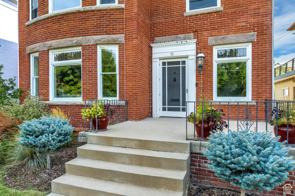 Doorway to property with brick siding