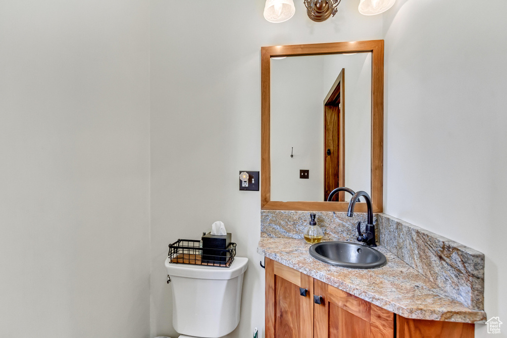 Half bathroom with vanity and toilet
