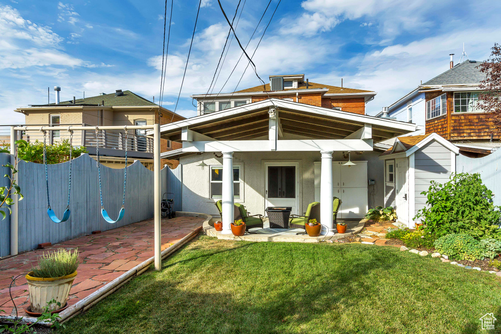Rear view of property with a patio area, stucco siding, central AC unit, and ceiling fan