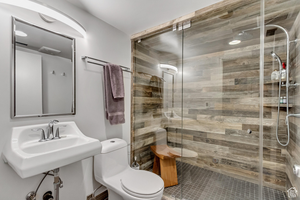 Full bath with toilet, a stall shower, and tile patterned floors