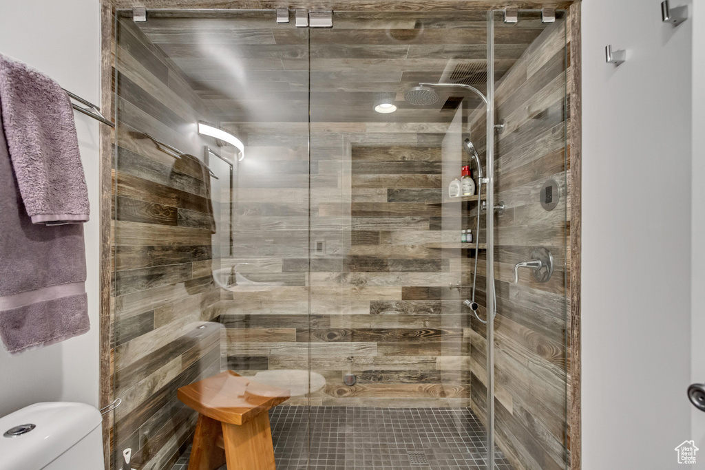 Full bathroom with toilet, a shower stall, and a sauna