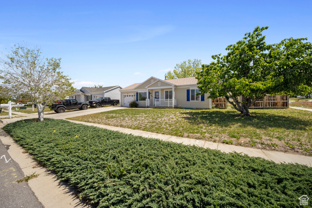Ranch-style home with a garage and driveway