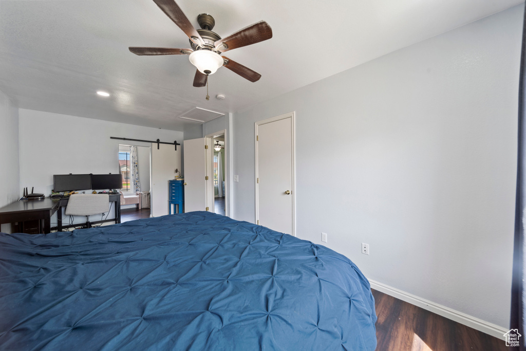 Bedroom with wood finished floors, baseboards, and a ceiling fan