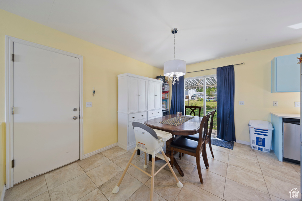 Dining room featuring light tile patterned flooring and baseboards