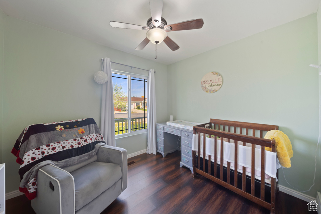 Bedroom featuring wood finished floors, baseboards, and a ceiling fan