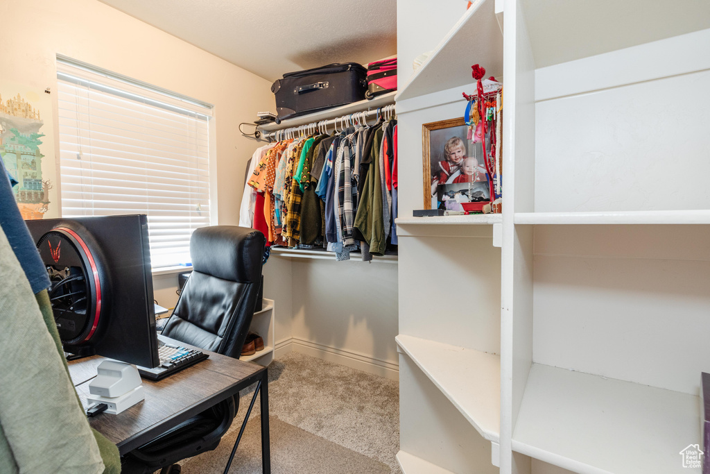 Carpeted home office featuring baseboards
