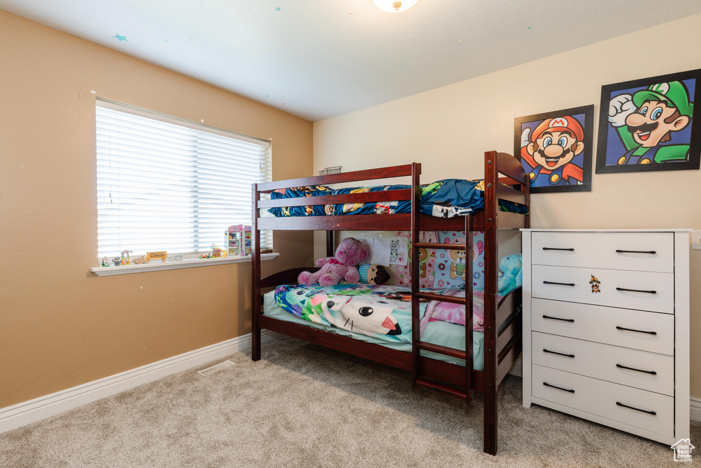 Bedroom with carpet floors and baseboards