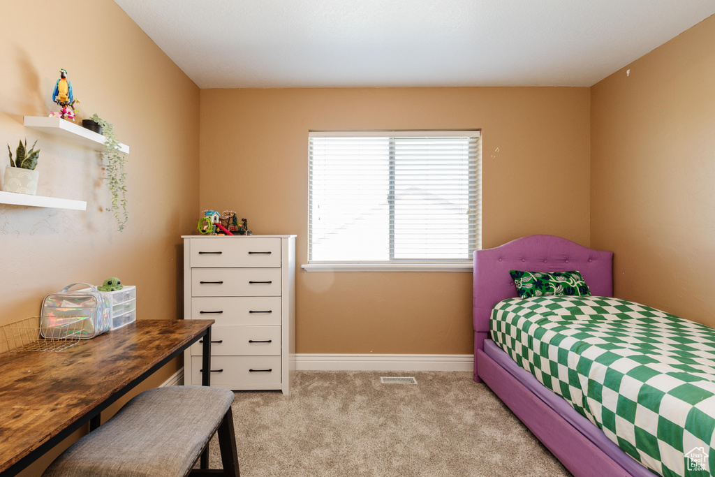 Carpeted bedroom featuring baseboards