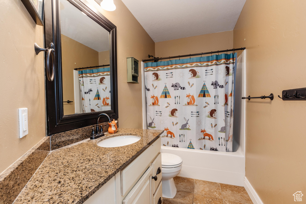 Bathroom featuring vanity, toilet, and shower / tub combo
