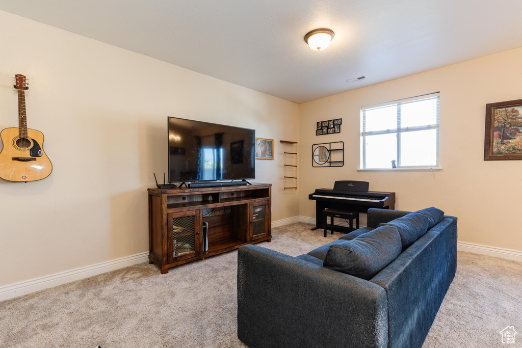 Carpeted living room with baseboards