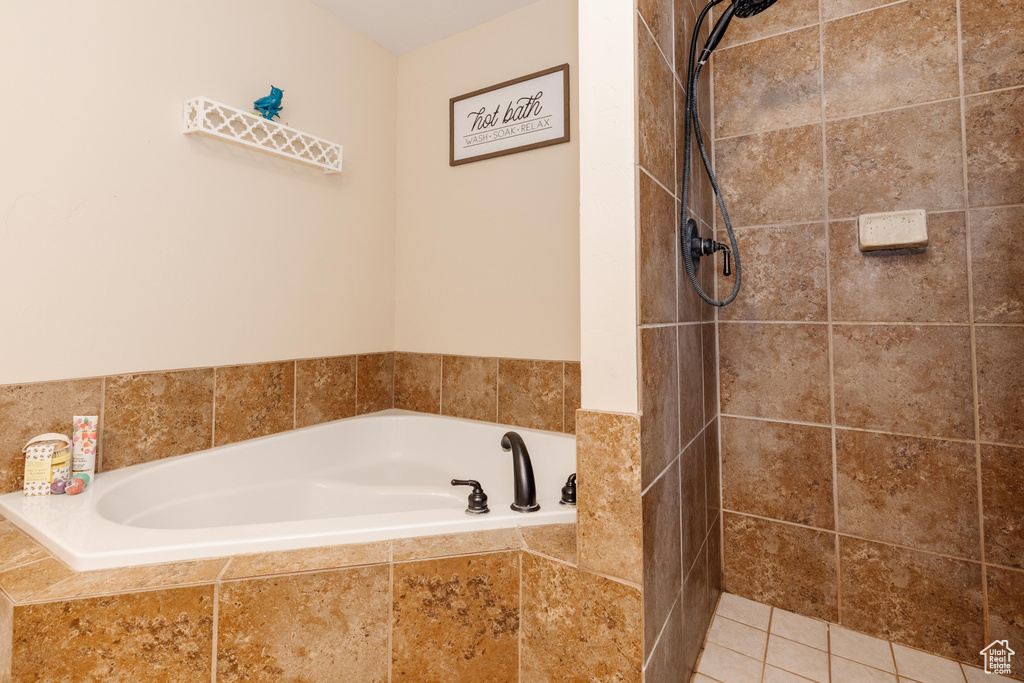 Full bath featuring a garden tub and a tile shower