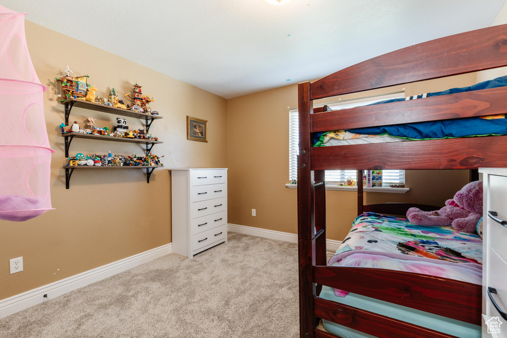 Bedroom featuring carpet floors and baseboards